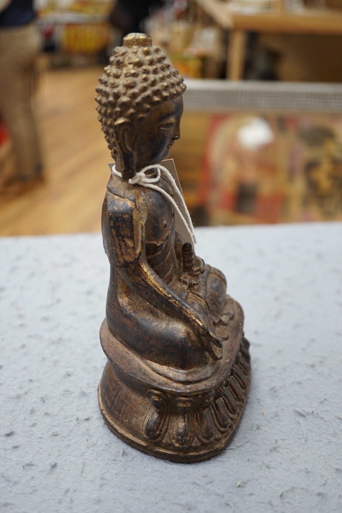 A Chinese gilt iron seated figure of Buddha, 19cm
